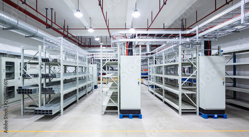 Bild auf Leinwand Modern industrial warehouse interior with extensive shelving and electrical cond
