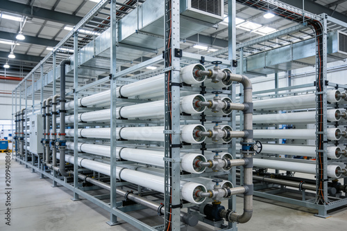 Industrial water filtration system with multiple membrane housings and piping