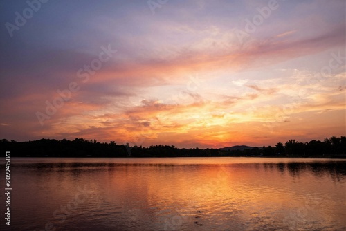 Tranquil sunset over calm lake with vivid sky reflections