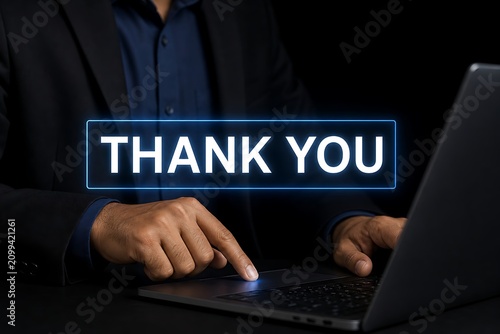 Businessman typing thank you message on laptop keyboard in dark office environment