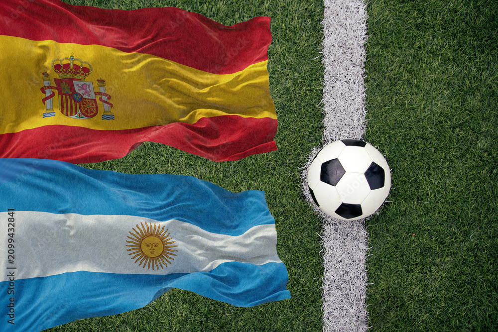 Obraz premium Soccer ball and the flag of Argentina and Spain