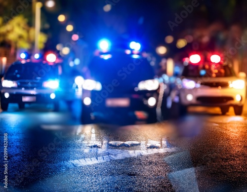 blurred background of police flashing lights at the crime scene