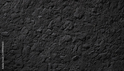 rough grainy black stone texture background with dark gray sand like surface high resolution seamless backdrop for industrial design minimalist interior renderings and premium product mock ups