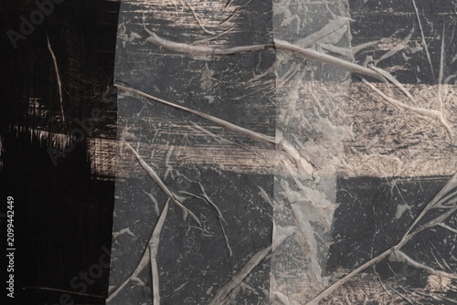 Crumble wrinkled paper pieces collage. Art Poster wall. Abstract grunge dirty black, beige white texture contrast background.