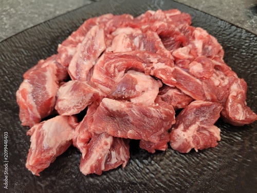 Fresh Raw Beef Rib Fingers Cut on Dark Textured Plate