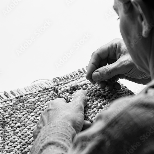 Hands Weaving Textile on Loom Closeup.