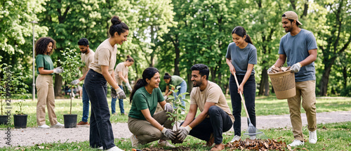 Indian Volunteers Planting Trees Together During Community Environmental Conservation Event In Public Park generative ai