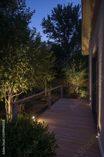Garden Path Lights Guide the Way on a Wooden Deck at Night in a Residential N...