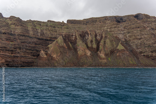 Lanzarote island in green in an unususaly rainy winter  province of Las Palmas Canary islands Spain Cliffs of northern Lanzarote from a boat sailing towards La Graciosa in the Chinijo Archipelago.