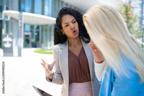 Businesswomen having argument outside office building