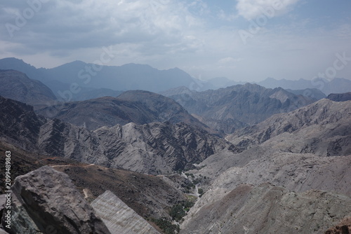 Foto Layered Mountain Ranges under Cloudy Sky in Oman