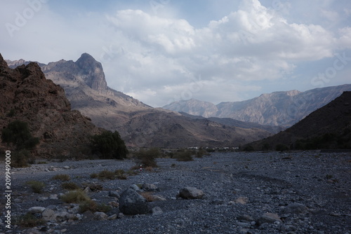 Obraz na płótnie Dry Wadi Valley between Rugged Mountains in Oman
