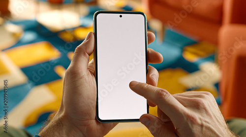 Closeup of hands holding a modern smartphone with a blank screen