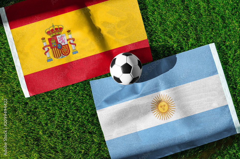 Fototapeta premium Spain vs Argentina, Final, national flags before international football match, football on green grass with stadium in the background, East Rutherford, July 19, 2026.