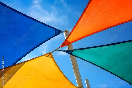Playground Shade Sails Forming Colorful Triangles Against Blue Sky Create A Vibrant Modern Recreational Landscape