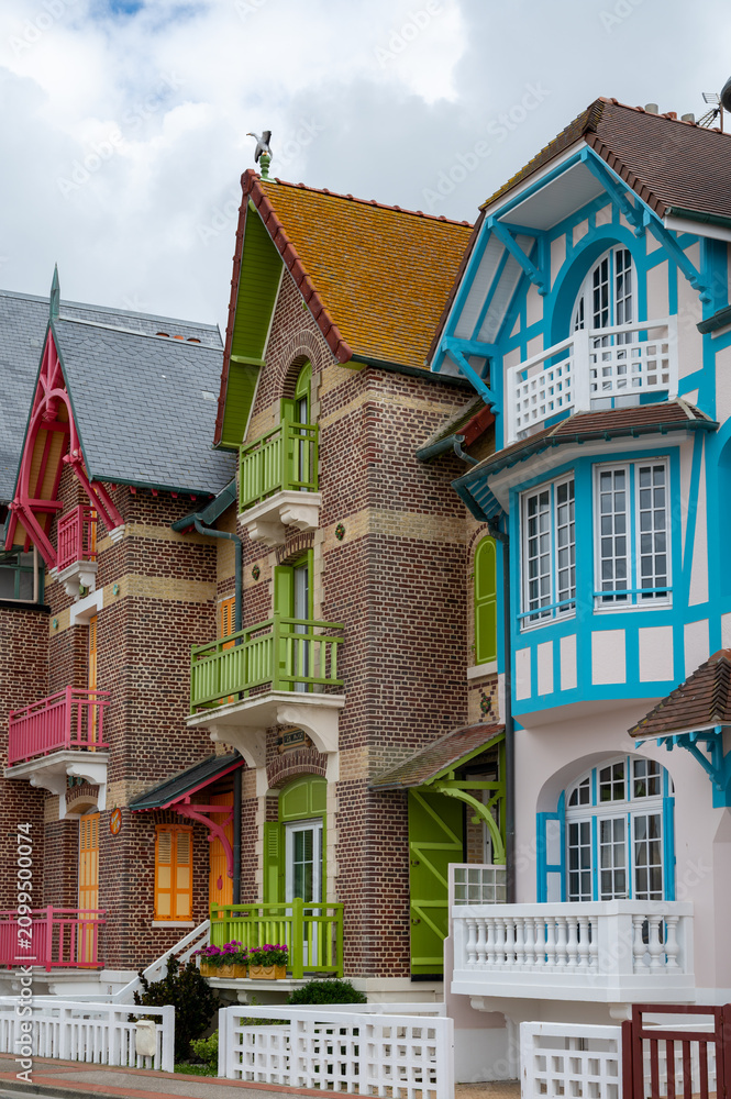 Fototapeta premium Houses of Mers-les-Bains, seaside town with 19th-century sea-bathing villas with colorful wooden balconies and white chalk cliffs, tourists destination in France