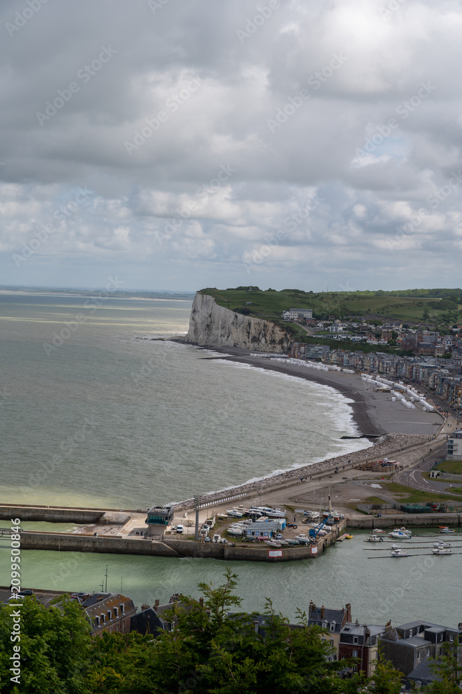 Fototapeta premium Mers-les-Bains, seaside town with 19th-century sea-bathing villas with colorful wooden balconies and white chalk cliffs, tourists destination in France