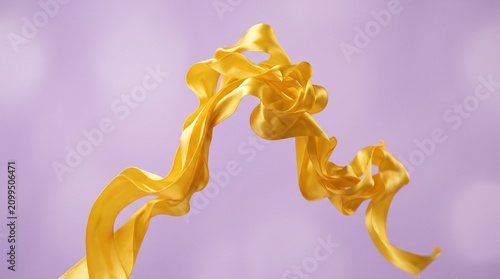 Abstract yellow satin ribbon flowing and twisting in midair against a soft purple background