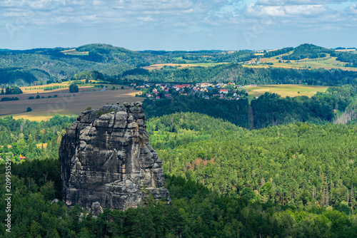 Bild auf Leinwand Falkenstein sandstone cliff overlooking fields and forest in Saxon Switzerland