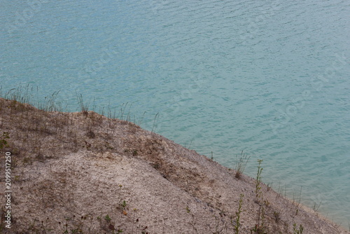 Kaolin quarry shoreline with turquoise water