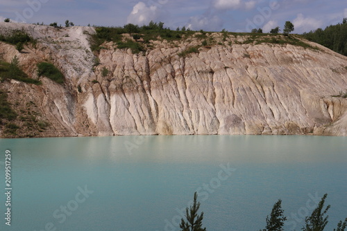 Turquoise lake and white kaolin cliffs in a quarry