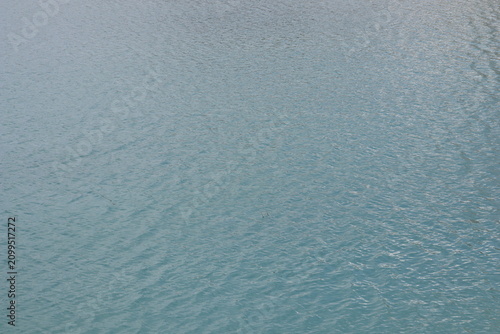 Turquoise water surface with natural ripples