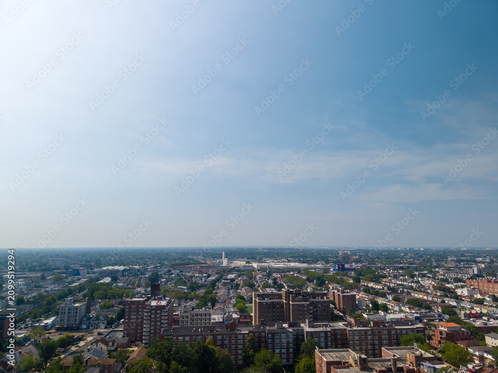 Fototapeta premium Residential buildings sprawling urban area under blue sky