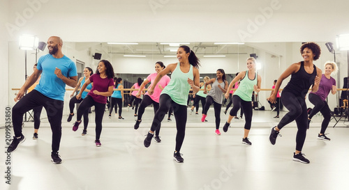 Diverse group fitness class dancing together