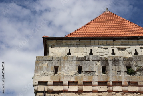Historic fortress tower with red tiled roof