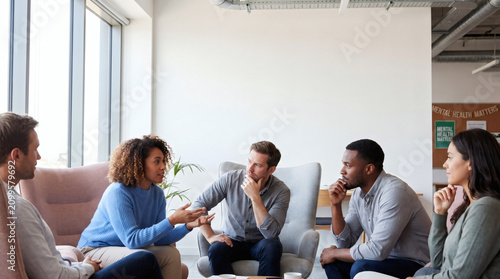 Diverse group of people in a support group session discussing mental health matters