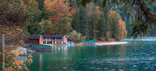 фотографія Eibsee lake boathouse with autumn forest reflections