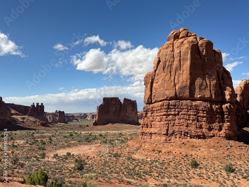 Layered Entrada Sandstone monoliths of the Courthouse Towers area rising from the desert floor in Arches National Park Utah