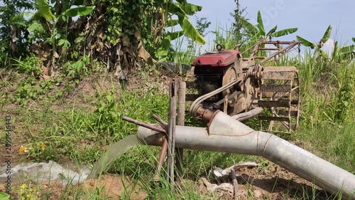 4K footage of Diesel Irrigation Pump Gushing Water into Green Rice Field Thailand