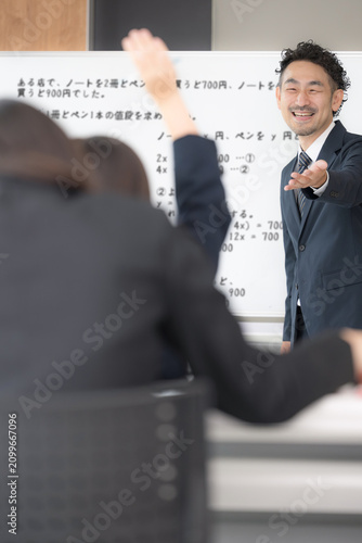 Fotografie A scene in a school classroom showing middle school students and high school gir