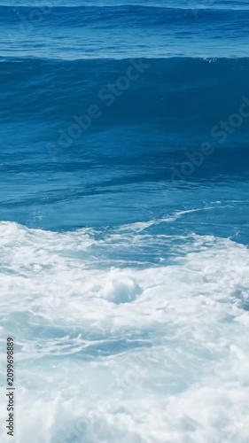 Powerful blue ocean wave crashing with white sea foam