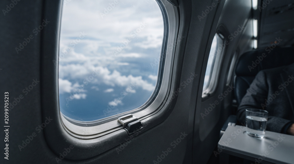 Fototapeta premium Airplane Window Above Clouds