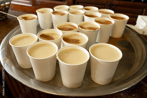 Traditional Turkish salep boza drink with cinnamon in paper cups
