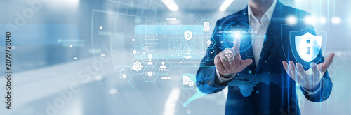 Quadro su tela IT specialist hand touching information security shield on virtual display to protect sensitive data, prevent cyber threats and ensure privacy compliance for corporate network systems