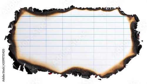 Burnt white lined paper sheet with charred edges isolated on a white background for creative design projects