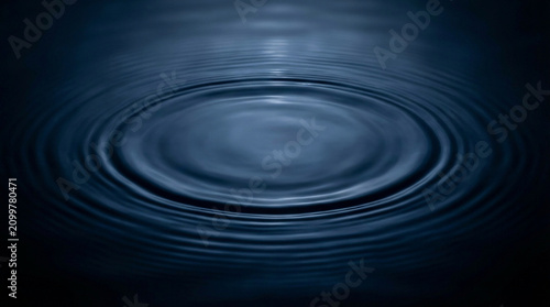 Принти на полотні Concentric water ripples spreading across a calm dark blue surface, abstract wat