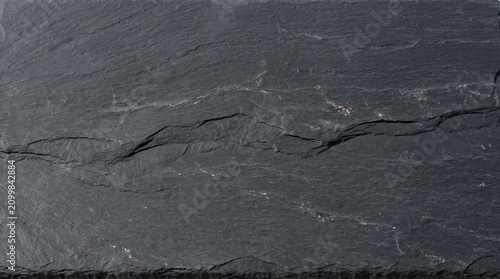 Dark slate stone texture. Charcoal grey rocky surface