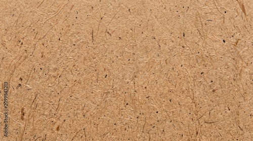 Recycled kraft paper texture. Brown cardboard background fibers