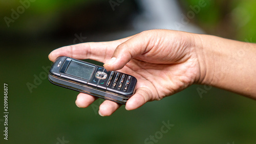Using a mobile phone in the 2000s. One type of vintage mobile phone.