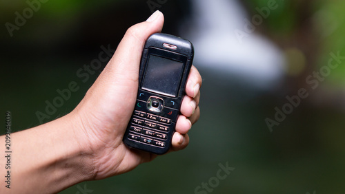 Using a mobile phone in the 2000s. One type of vintage mobile phone.