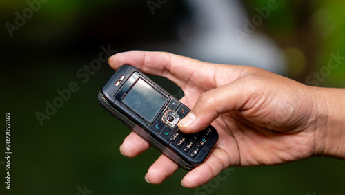 Using a mobile phone in the 2000s. One type of vintage mobile phone.