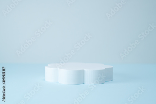 Minimalist Flower-Shaped Product Display Podium on Light Blue Background