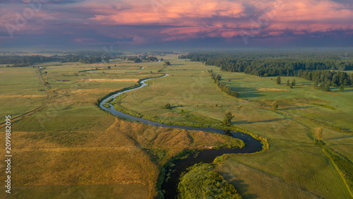 Obraz na plátne Meandering Liwiec River in the Masovian Voivodeship, Poland, during the summer season, illustrating its natural flow regime and the environmental significance of its water resources
