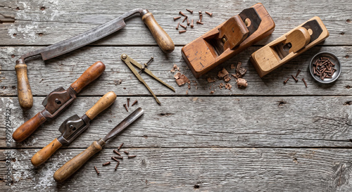 Overhead flat lay of Shaker woodworking tools on weathered lobster trap wood