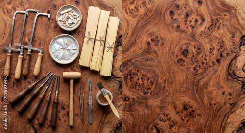 Hyper-realistic top down view of Moroccan wood marquetry tools on Thuya burl