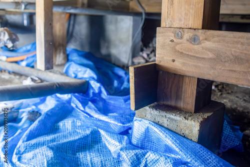Wooden foundation support under a house during repair work